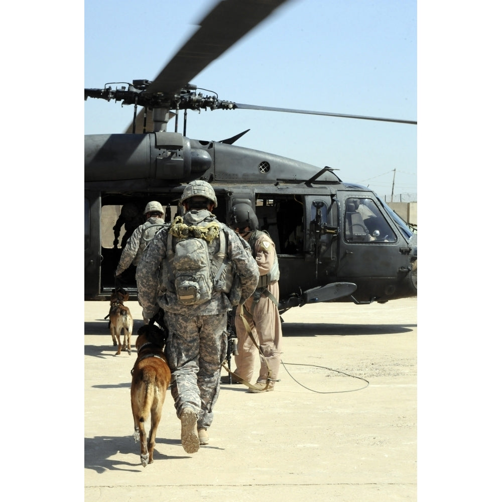 Military working dog handlers board a helicopter Poster Print Image 1