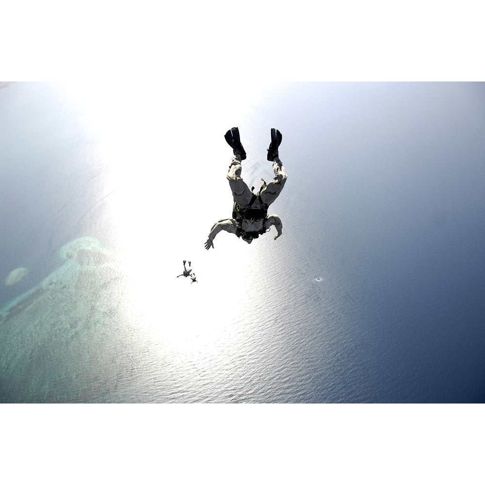 U.S. Air Force pararescuemen conducting a pararescue training jump from an HC-130 Hercules Poster Print Image 2