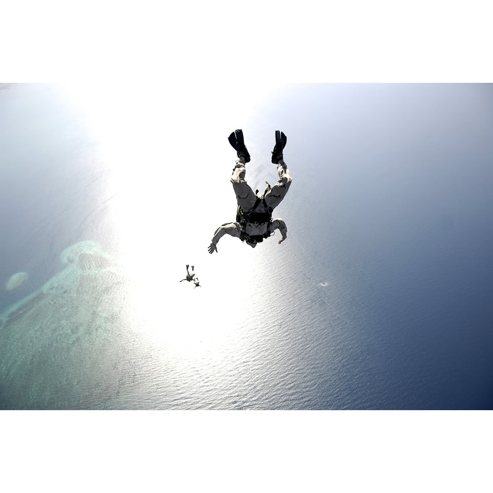 U.S. Air Force pararescuemen conducting a pararescue training jump from an HC-130 Hercules Poster Print Image 1