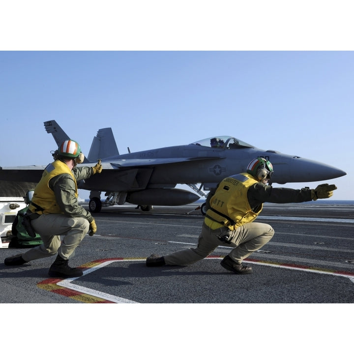 Shooters aboard the USS George H.W. Bush give the go-ahead signal to launch an F/A-18 Super Hornet Print Image 2