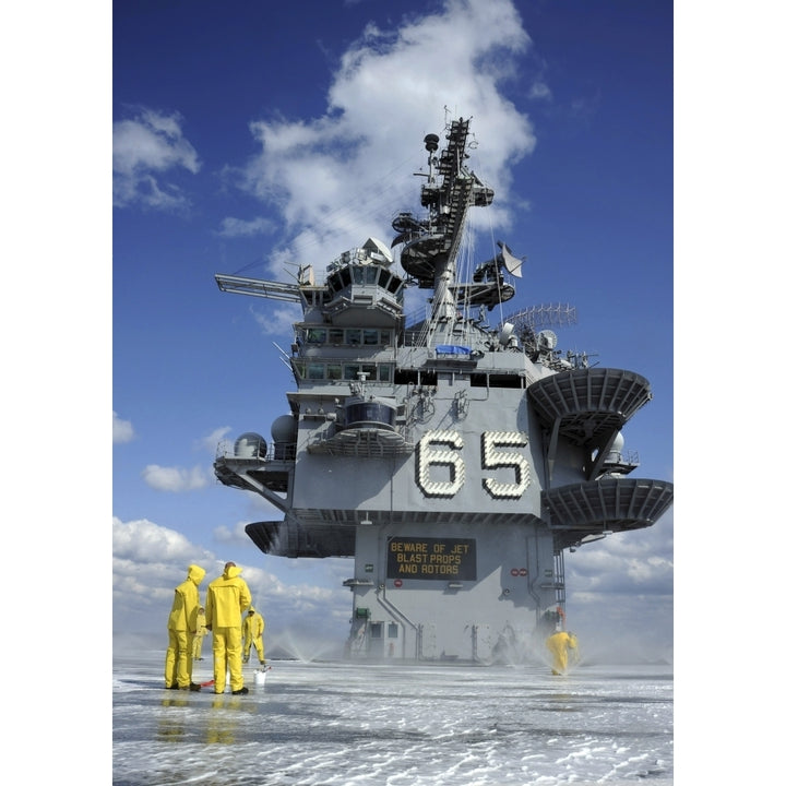 Air department Sailors test the sprinkler system on the flight deck of the USS Enterprise Poster Print Image 1