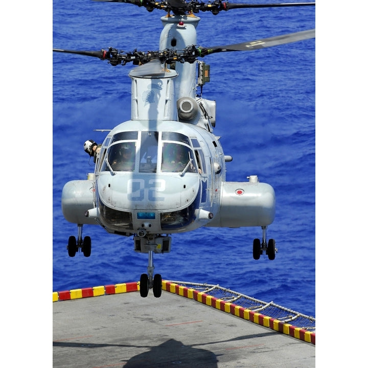 A CH-46E Sea Knight helicopter prepares to land on the flight deck of USS Peleliu Poster Print Image 2