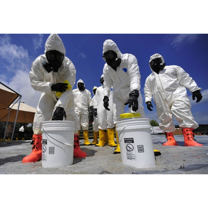 U.S. Soldiers from the 457th Chemical Battalion sponge off their level A protective suits Poster Print Image 2