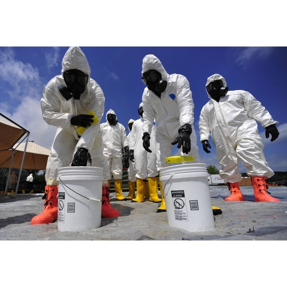 U.S. Soldiers from the 457th Chemical Battalion sponge off their level A protective suits Poster Print Image 1