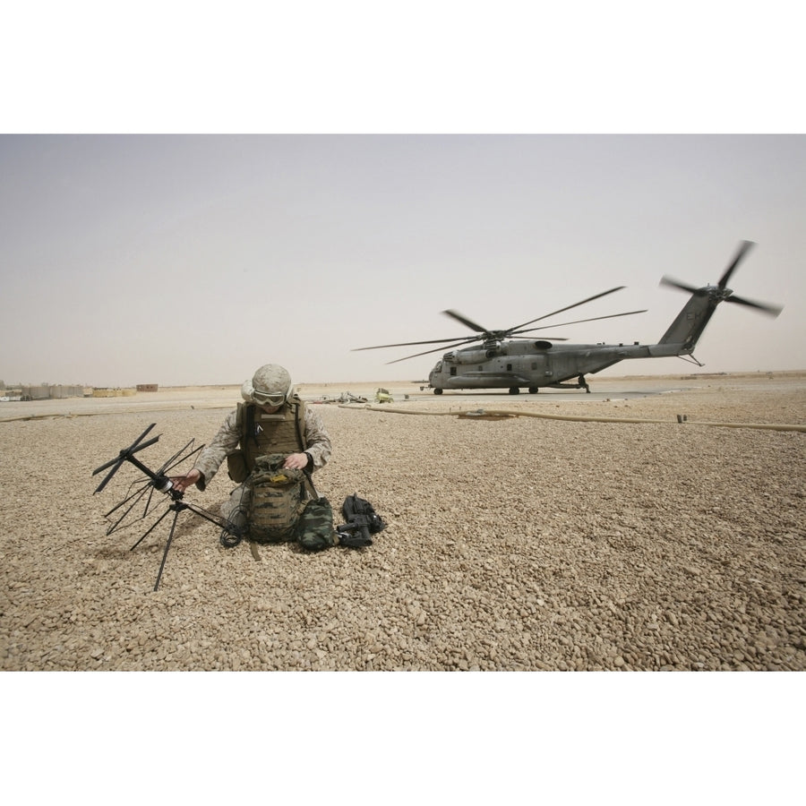 A field radio operator sets up satellite communication Poster Print Image 1