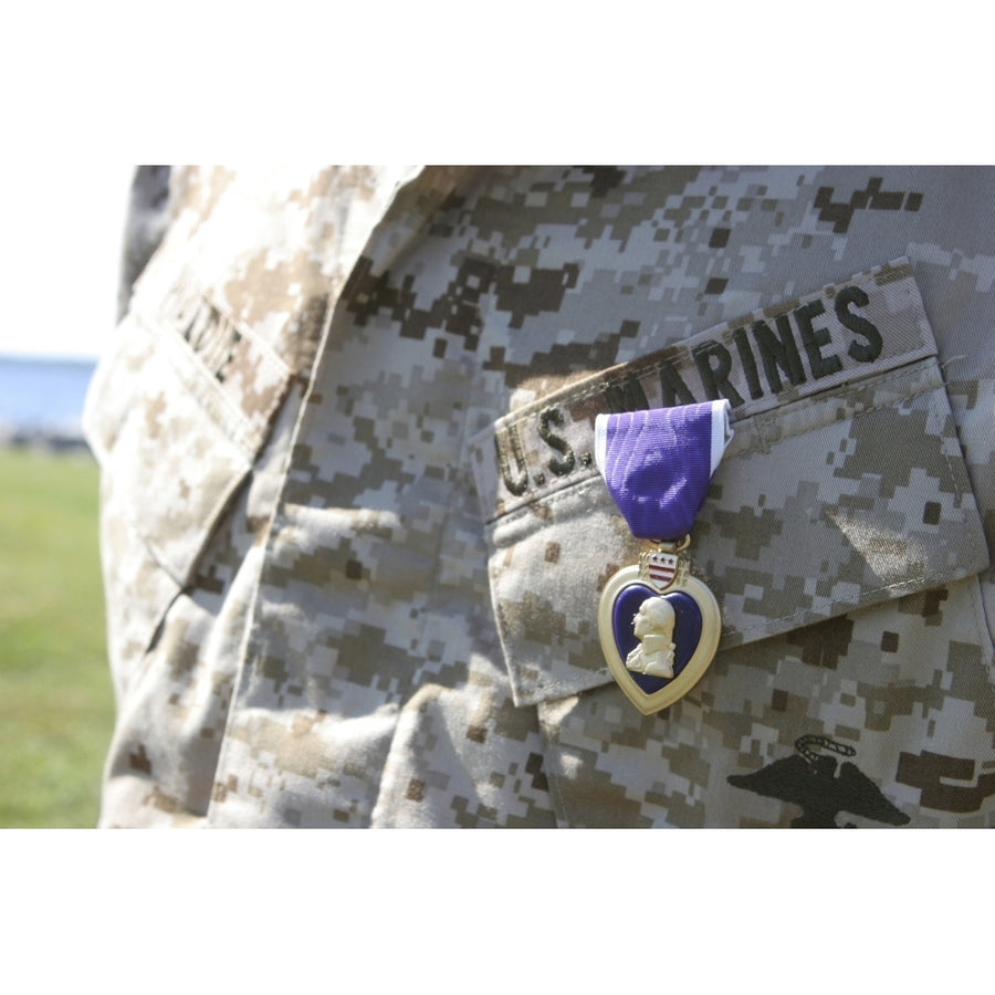 The Purple Heart award hangs over the heart of a U.S. Marine Poster Print Image 1