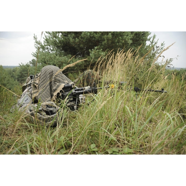 A U.S. Army Soldier and a German Bundeswehr soldier camouflage themselves Poster Print Image 2