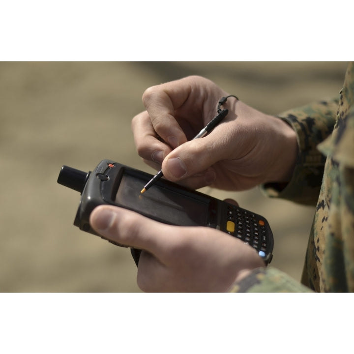 U.S. Marine using GPS capabilities on a handheld device to check his location Poster Print Image 2