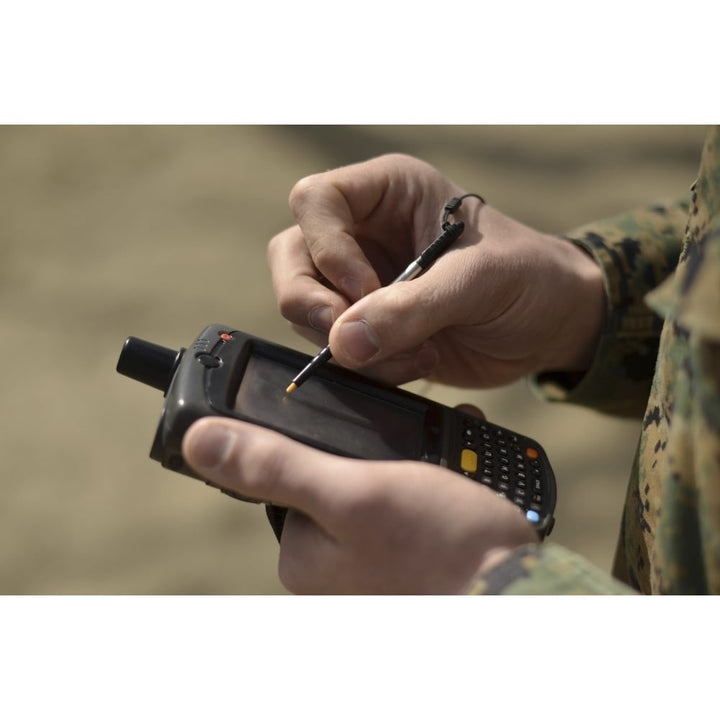 U.S. Marine using GPS capabilities on a handheld device to check his location Poster Print Image 1