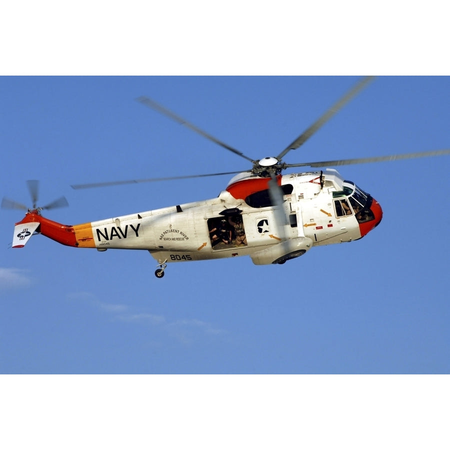 A UH-3H Sea King helicopter flies a search and rescue training mission Poster Print Image 1