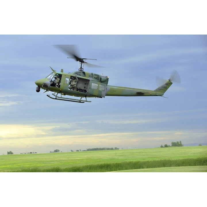 A UH-1N Huey helicopter prepares to land at Minot Air Force Base North Dakota Poster Print Image 1