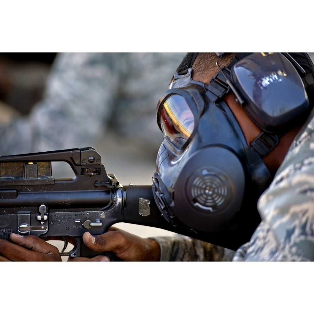 Air Force Basic Military Training trainee fires at his target while wearing his gas mask Poster Print Image 1