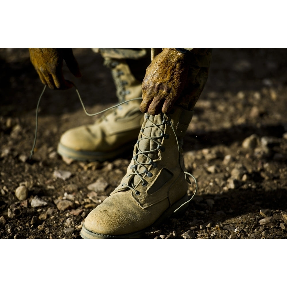 An Air Force Basic Military Training trainee reties his boots Poster Print Image 2