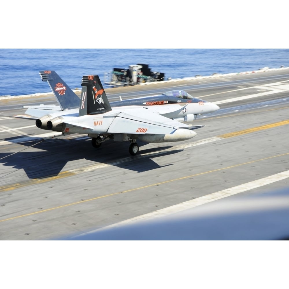 An F/A-18E Super Hornet lands aboard the aircraft carrier USS Ronald Reagan Poster Print Image 1