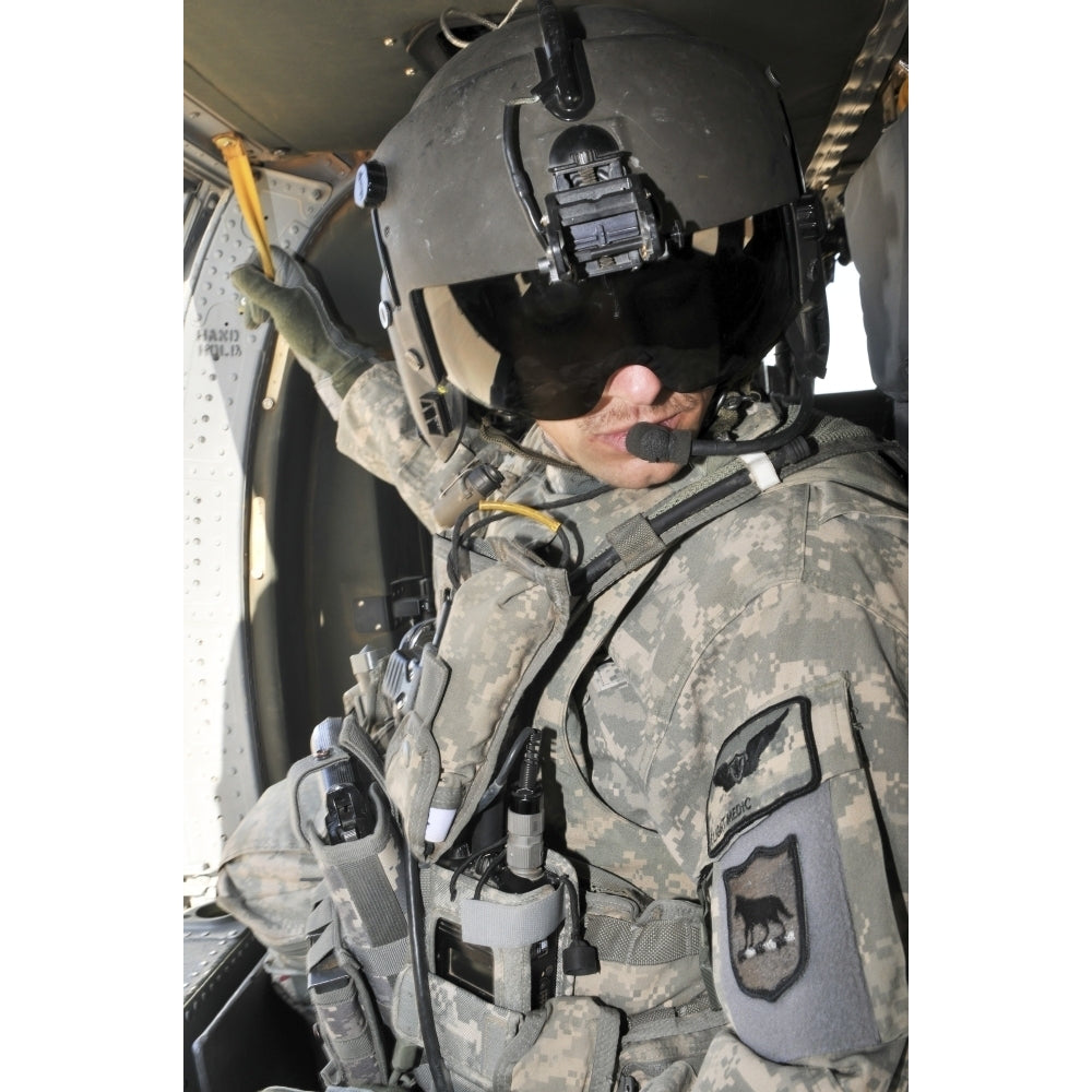 A flight medic conducts a daily pre-flight inspection at Al Asad Air Base Iraq Poster Print Image 2