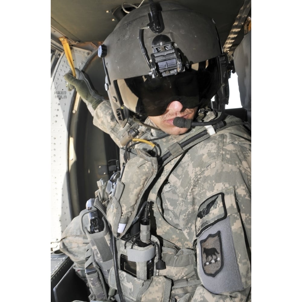 A flight medic conducts a daily pre-flight inspection at Al Asad Air Base Iraq Poster Print Image 1