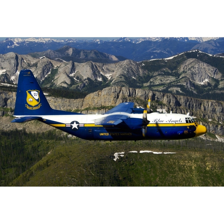 A C-130 Hercules Fat Albert plane flies over the Chinese Wall rock formation in Montana Poster Print Image 1