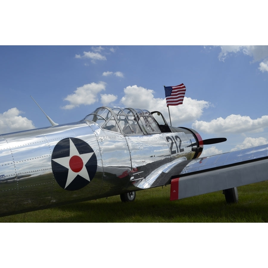 A BT-13 Valiant trainer aircraft with American Flag Poster Print Image 1