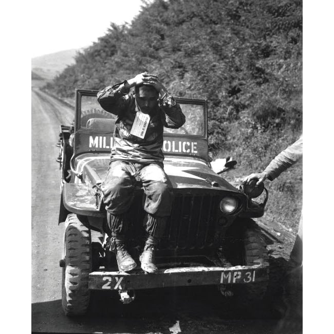 A North Korean prisoner of war sits on a military police vehicle Poster Print by Stocktrek Images Image 1