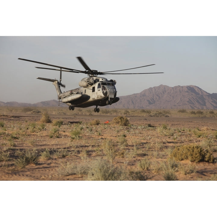 A U.S. Marine Corps CH-53 Sea Stallion helicopter lands to pick up Marines Poster Print Image 1