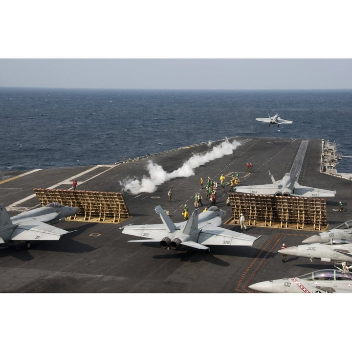 An F/A-18 Hornet launches from the aircraft carrier USS George Washington Poster Print Image 1