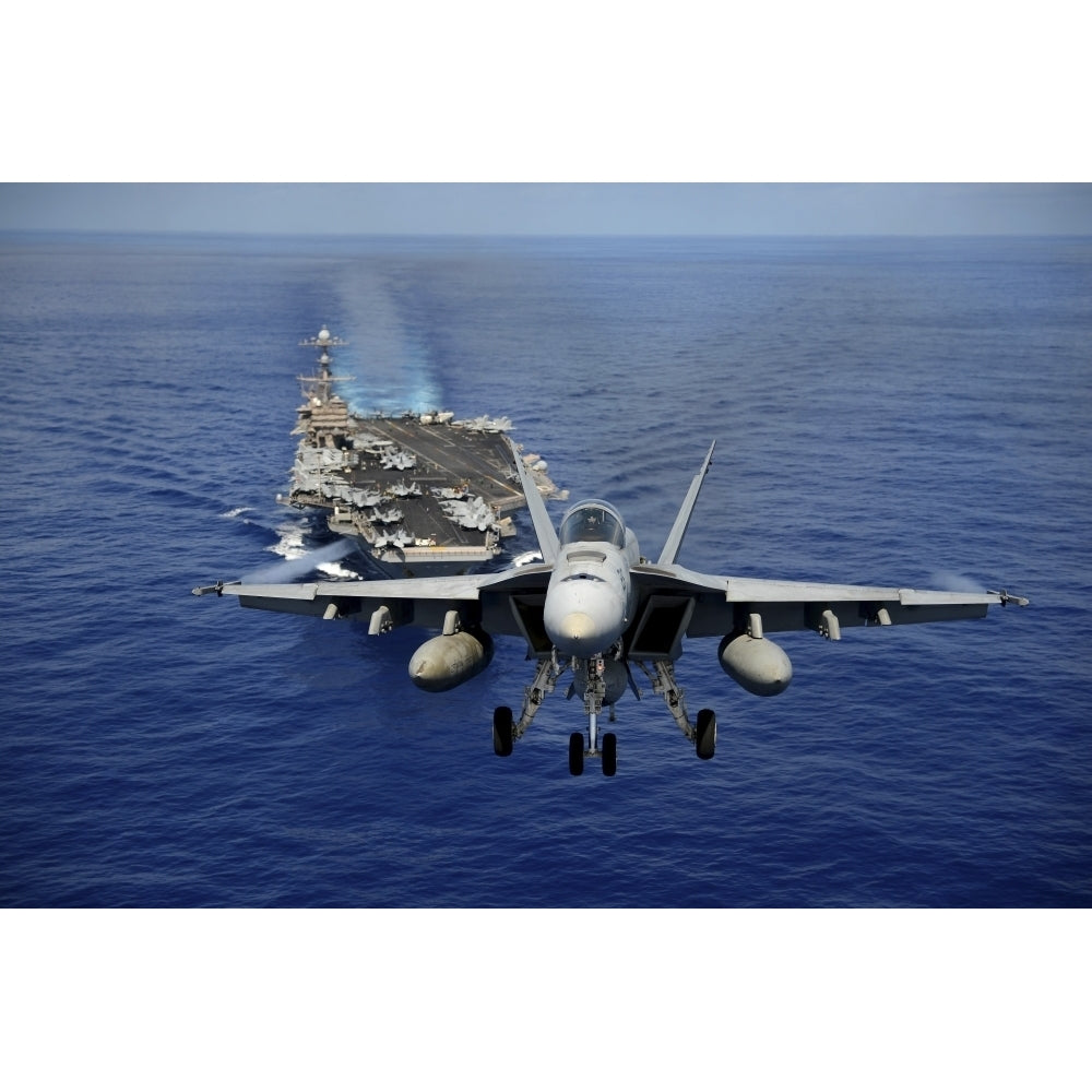 An F/A-18E Super Hornet flying above USS John C. Stennis Poster Print Image 2