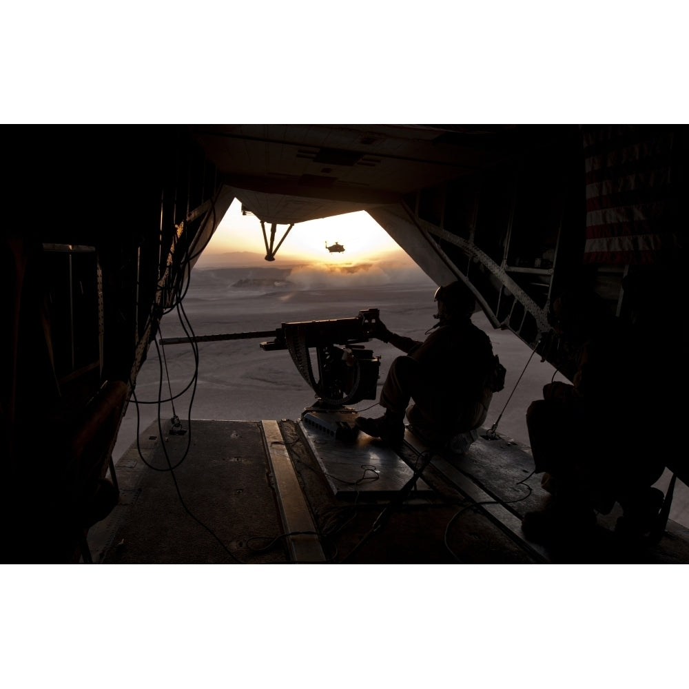 A U.S. Marine provides aerial security from a CH-53E Super Stallion Poster Print Image 1