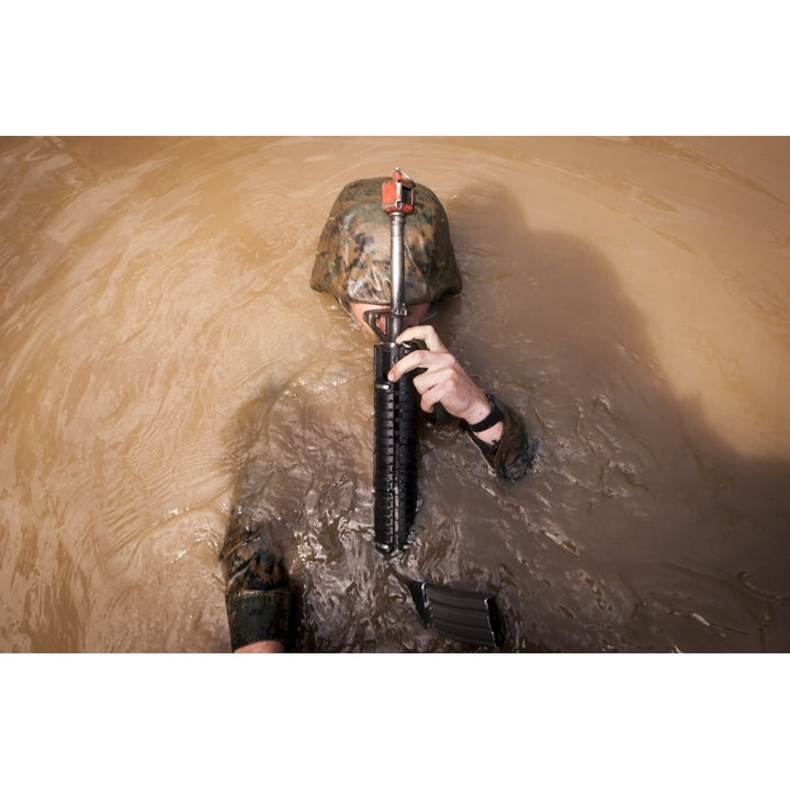 A U.S. Marine Corps back crawls through an obstacle Poster Print Image 1