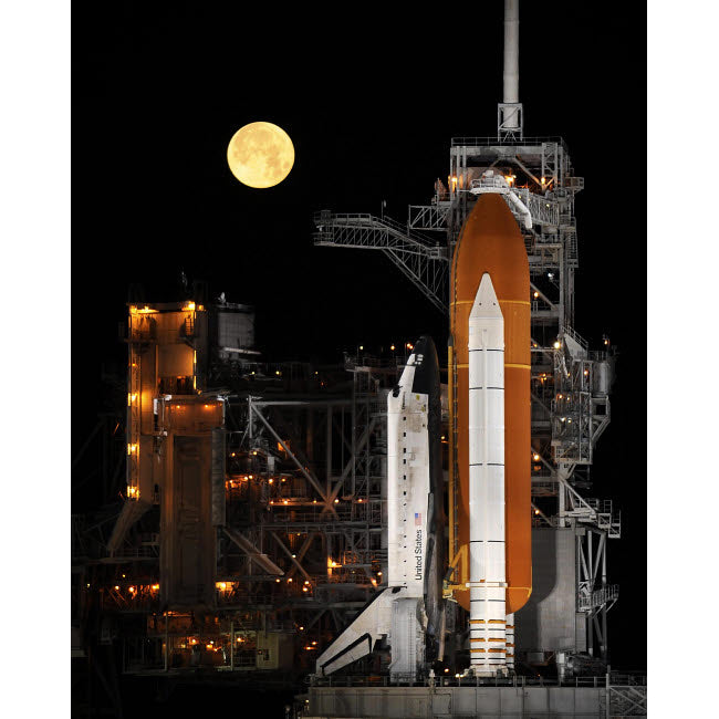 A nearly full Moon sets as Space Shuttle Discovery sits atop the launch pad Poster Print by Stocktrek Images Image 1