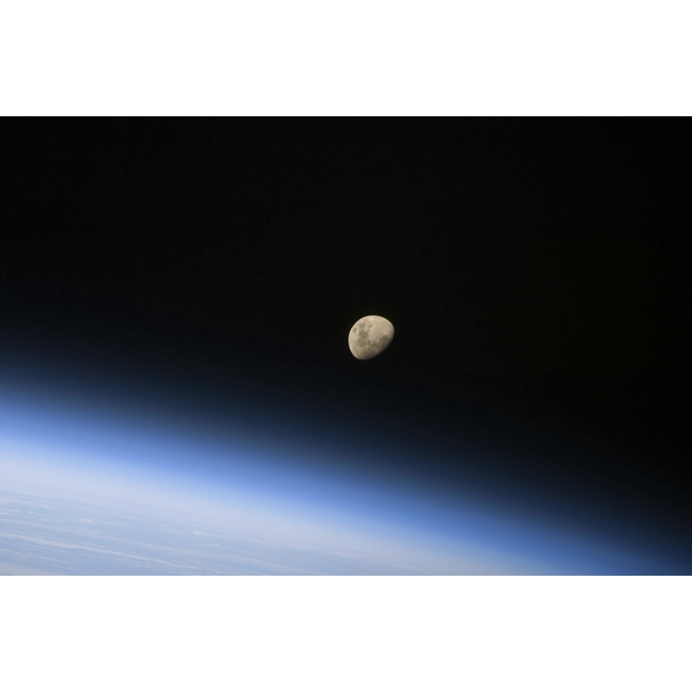 A gibbous moon visible above Earths atmosphere Poster Print Image 2