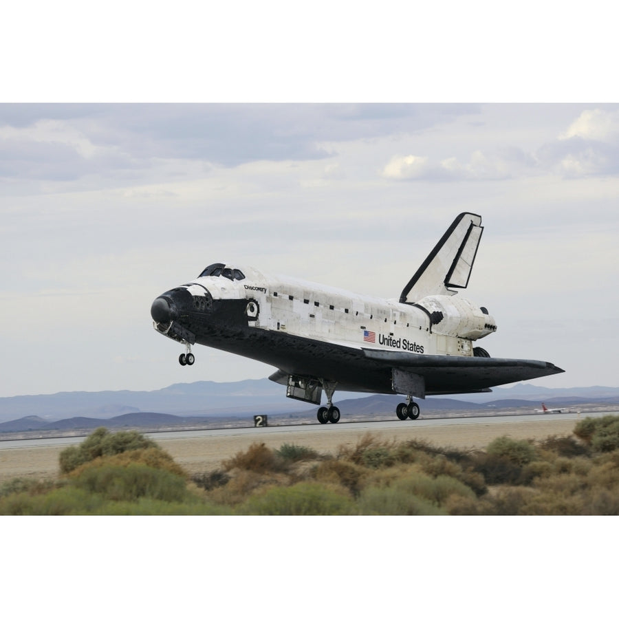 Space Shuttle Discoverys main landing gear touches down for landing Poster Print Image 1