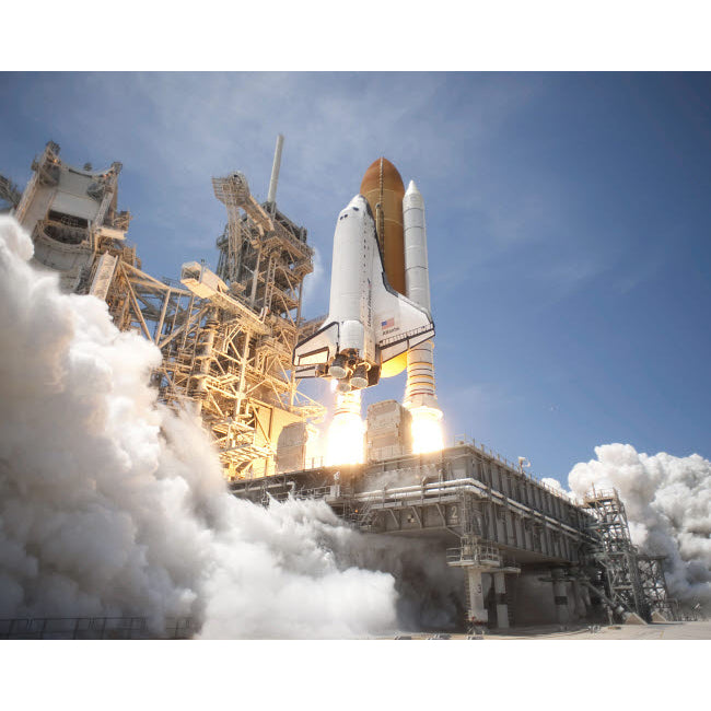 An exhaust plume forms under the mobile launcher platform on Launch Pad 39A as space shuttle Atlantis lifts off into orb Image 2