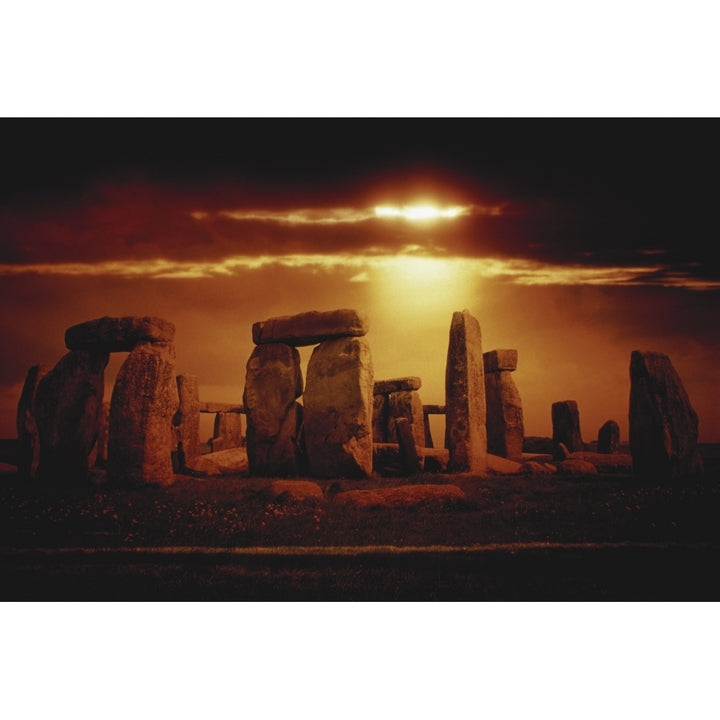 Composite of a sunset over Stonehenge Wiltshire England Poster Print Image 1