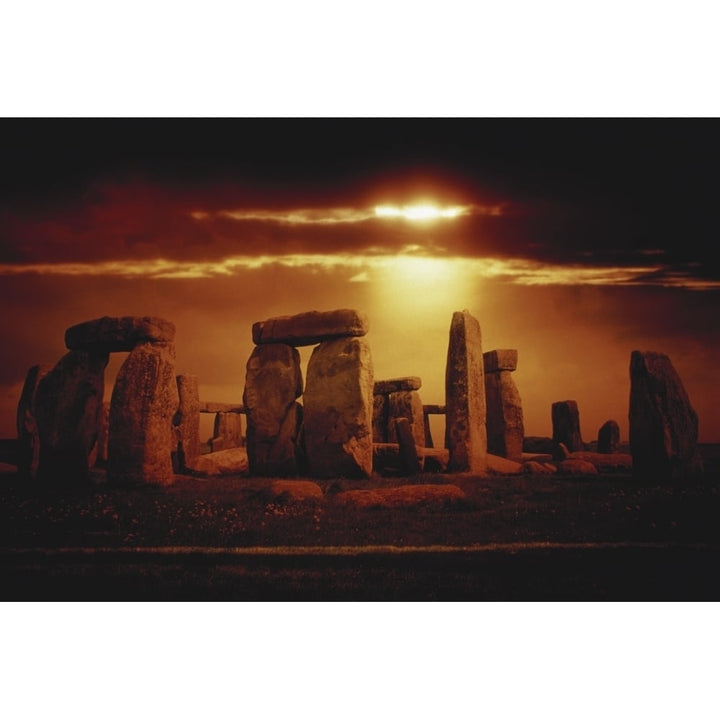 Composite of a sunset over Stonehenge Wiltshire England Poster Print Image 1