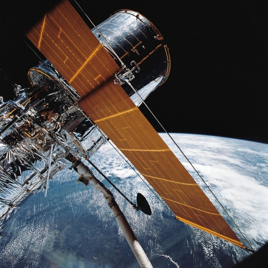 The Hubble Space Telescope backdropped by planet Earth Poster Print Image 1