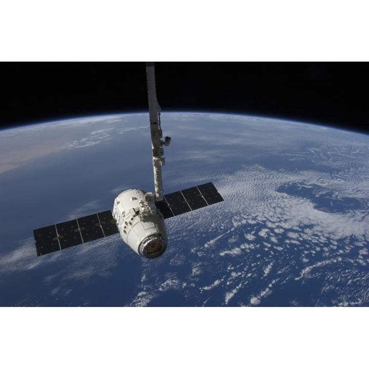 The SpaceX Dragon cargo craft prior to being released by the Canadarm2 robotic arm Poster Print Image 1