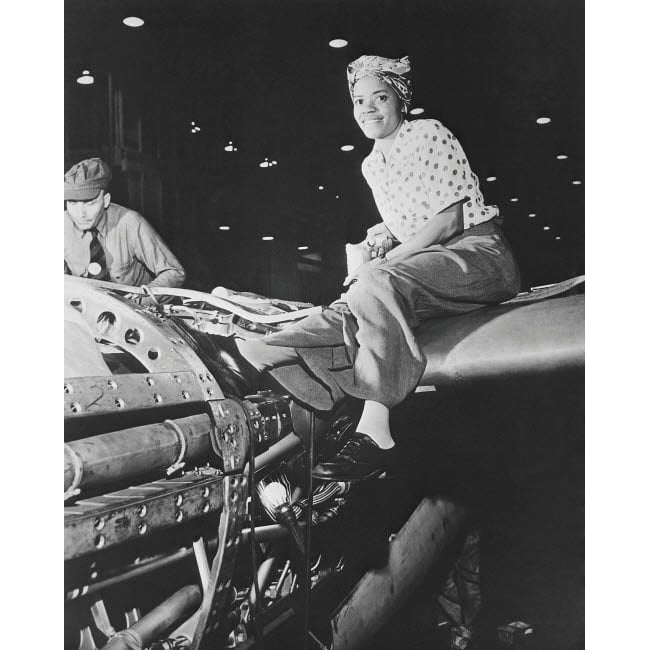 A female riveter working on the fabrication of an airplane Poster Print by Stocktrek Images Image 1