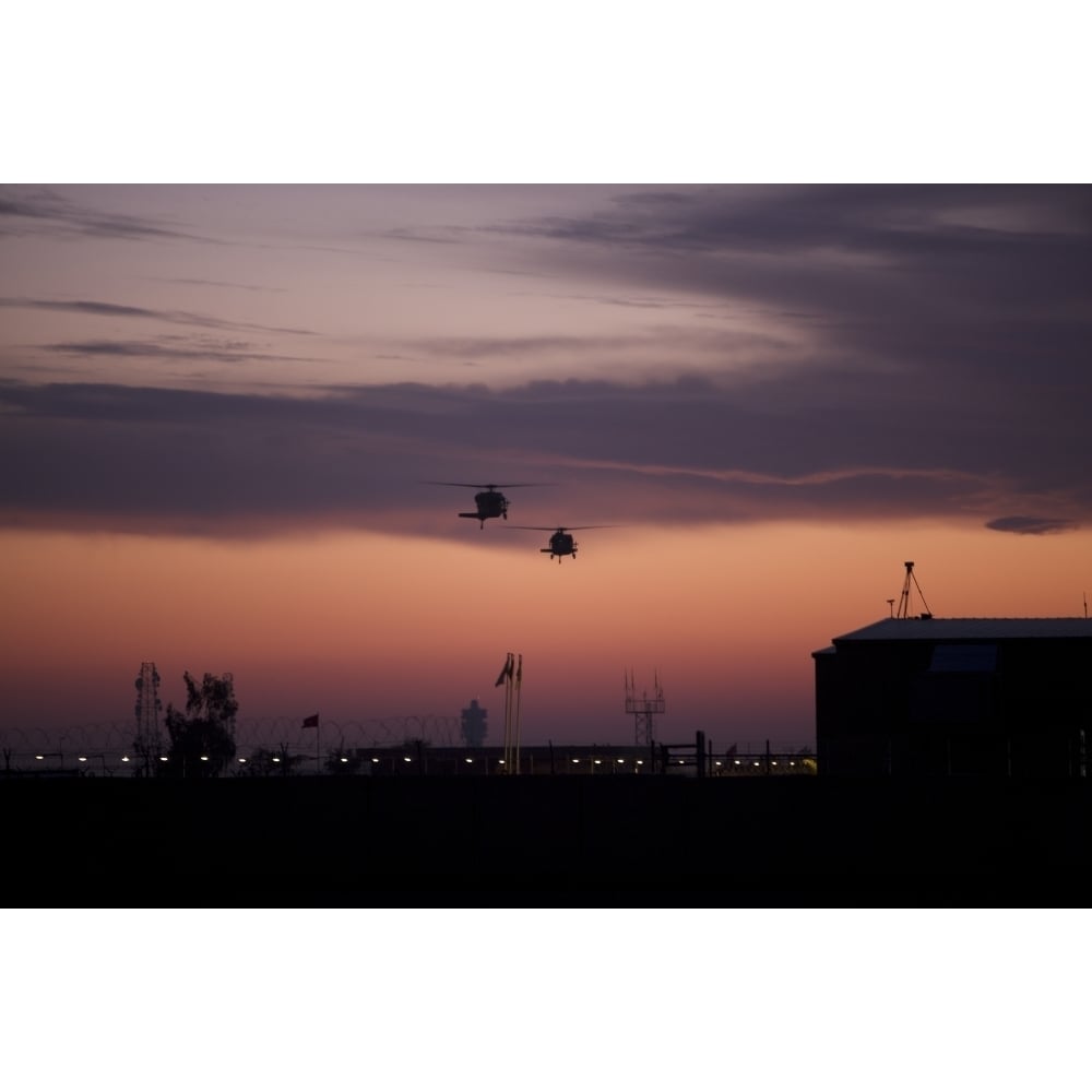 A pair of UH-60 Black Hawk helicopters approach their landing in Baghdad Iraq Poster Print Image 2