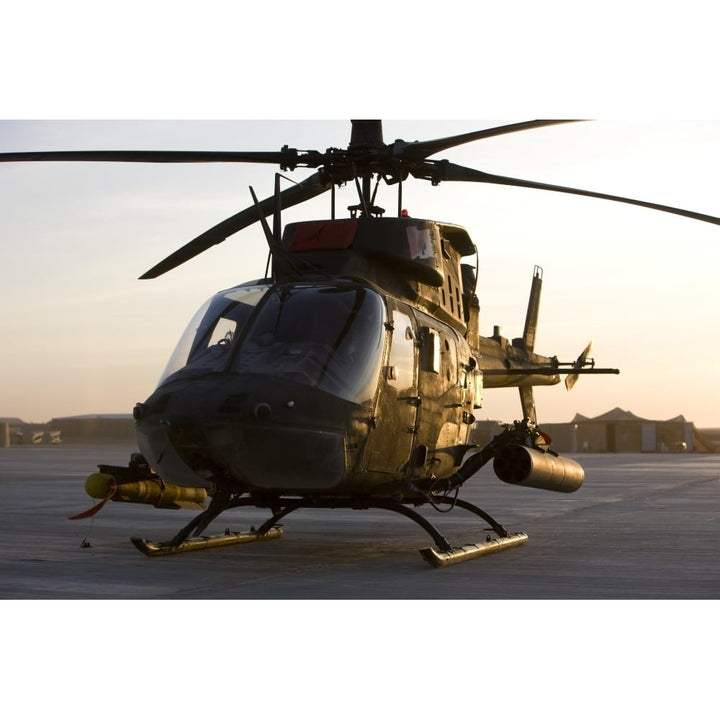 An OH-58D Kiowa during sunset Poster Print Image 1