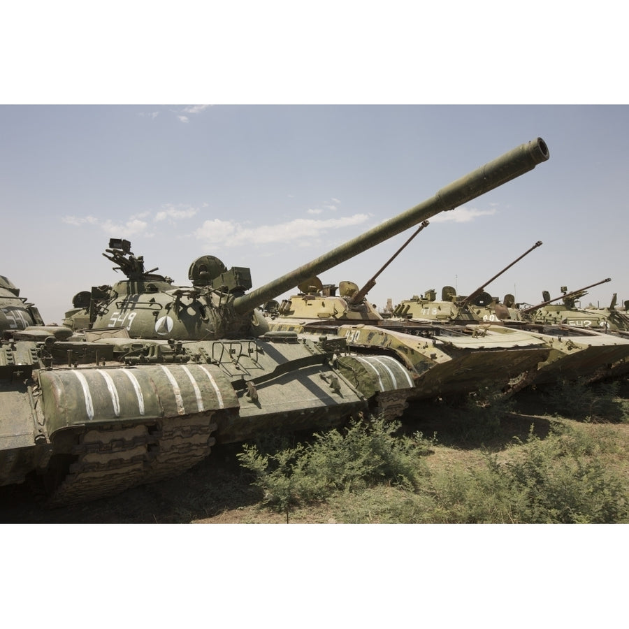 Russian T-54 and T-55 main battle tanks rest in an armor junkyard Poster Print Image 1