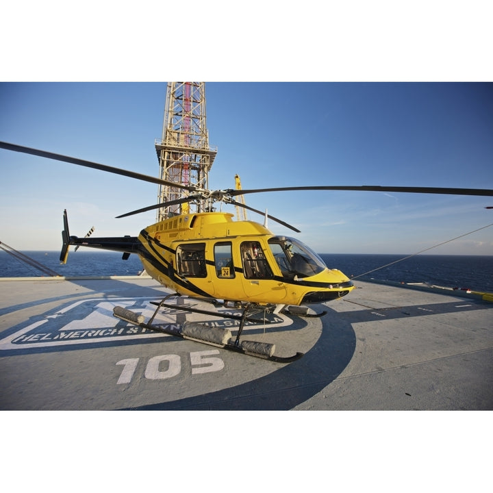 A Bell 407 utility helicopter on the helipad of an oil rig Poster Print Image 2