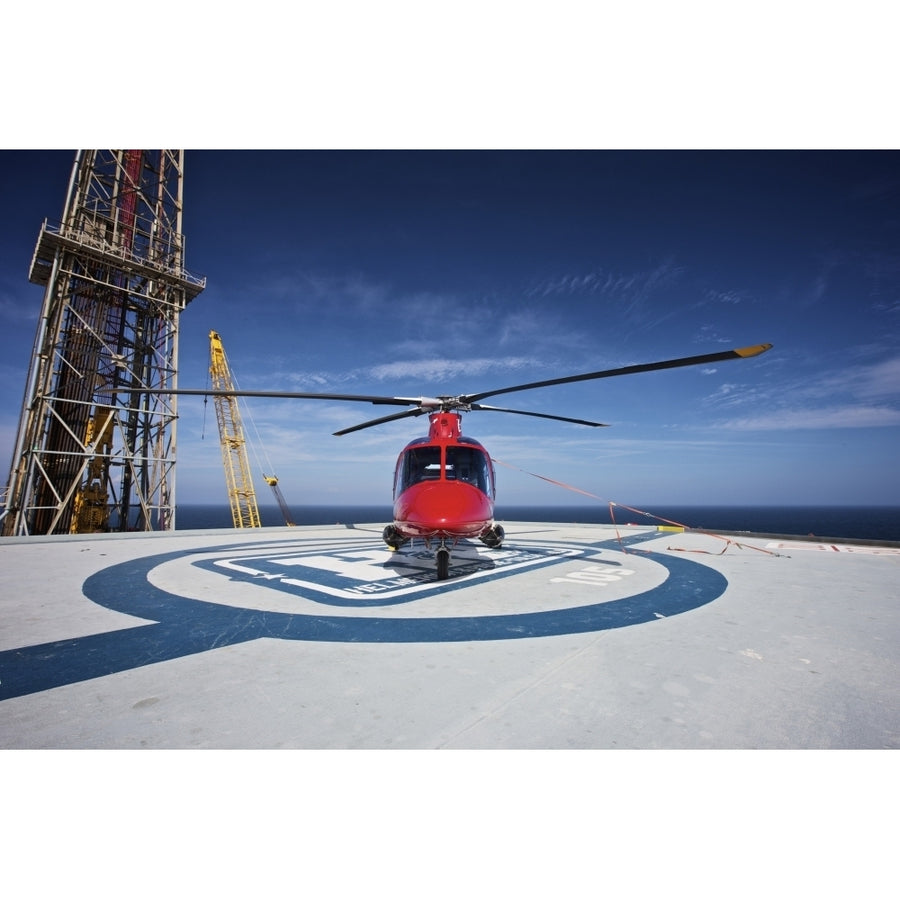 AgustaWestland AW109E utility helicopter on the helipad of an oil rig Poster Print Image 1