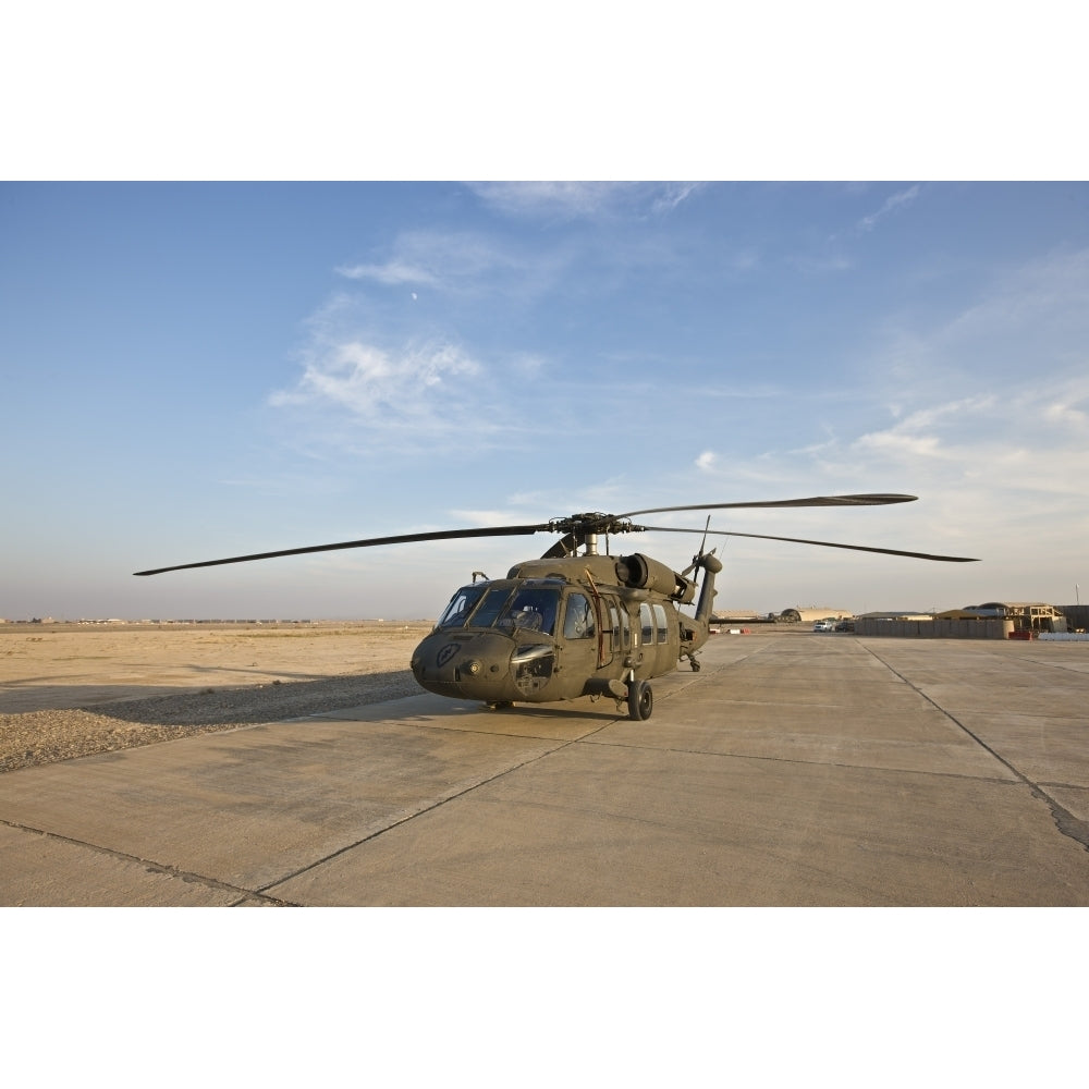 A UH-60 Black Hawk parked at a military base in Tikrit Iraq Poster Print Image 1