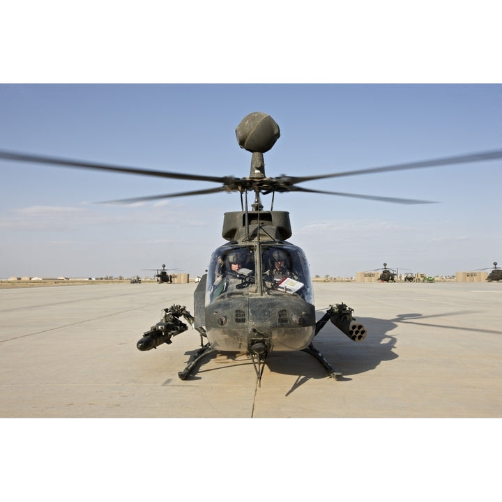 An OH-58D Kiowa helicopter prepares for liftoff from COB Speicher Poster Print Image 2