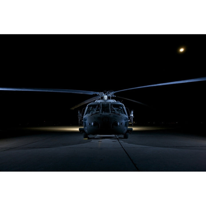 A UH-60 Black Hawk helicopter lit up by multiple external flash units Poster Print Image 1