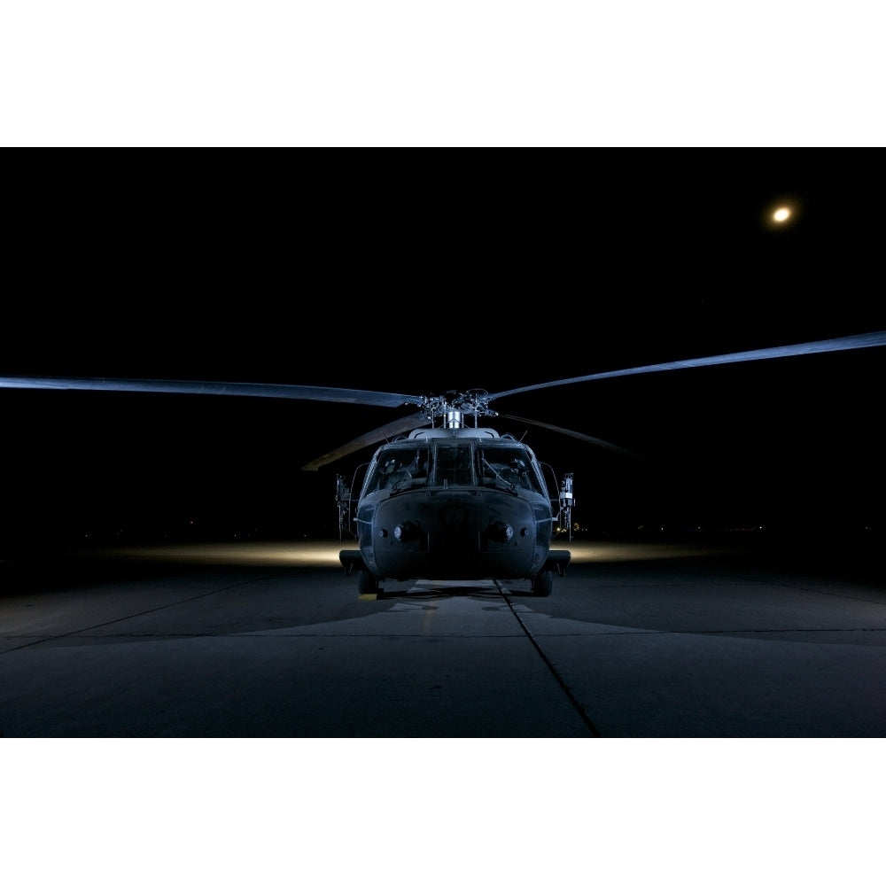 A UH-60 Black Hawk helicopter lit up by multiple external flash units Poster Print Image 2