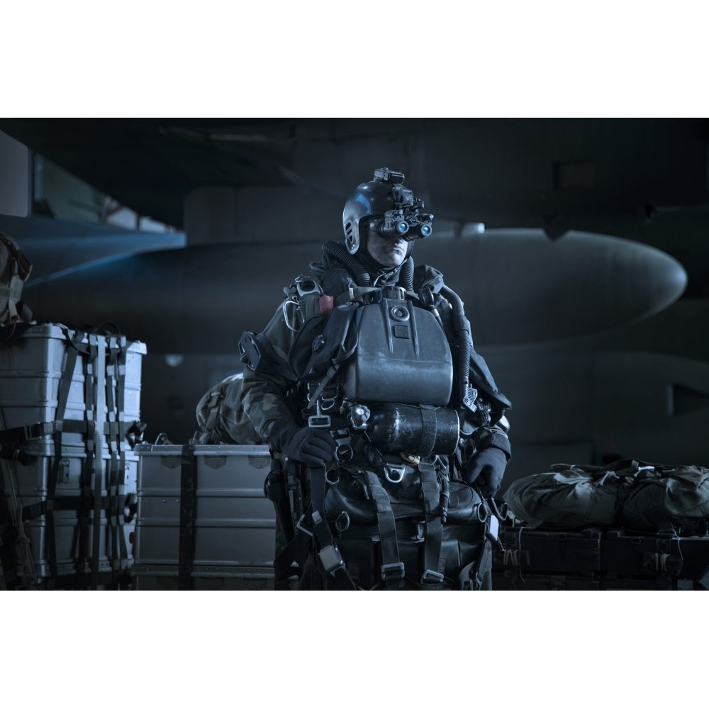 U.S. Navy Seal equipped with night vision prepares for HALO jump operations Poster Print Image 1