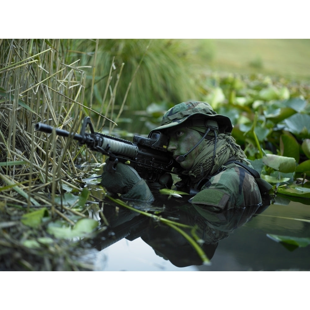 U.S. Navy SEAL crosses through a stream during combat operations Poster Print Image 2