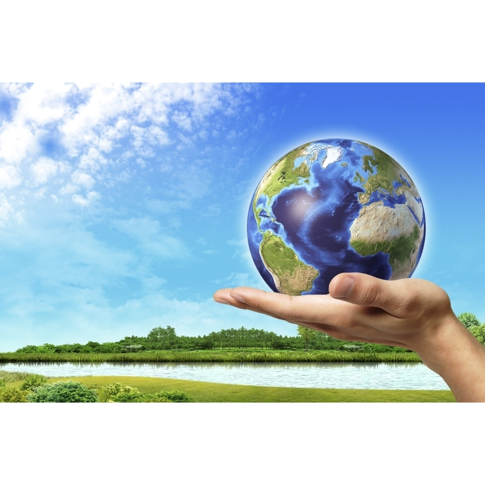 Human hand holding Earth globe with a green landscape background Poster Print Image 1