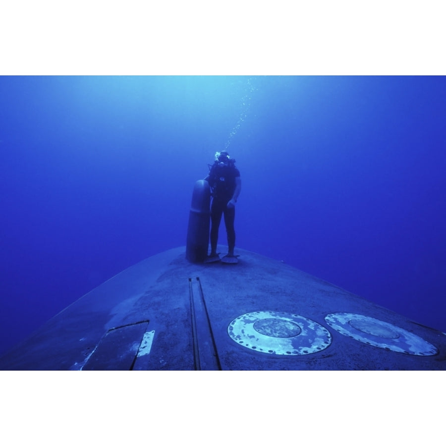 A Navy SEAL stands next to the sonar dome on the bow of the USS Kamehameha Poster Print Image 1